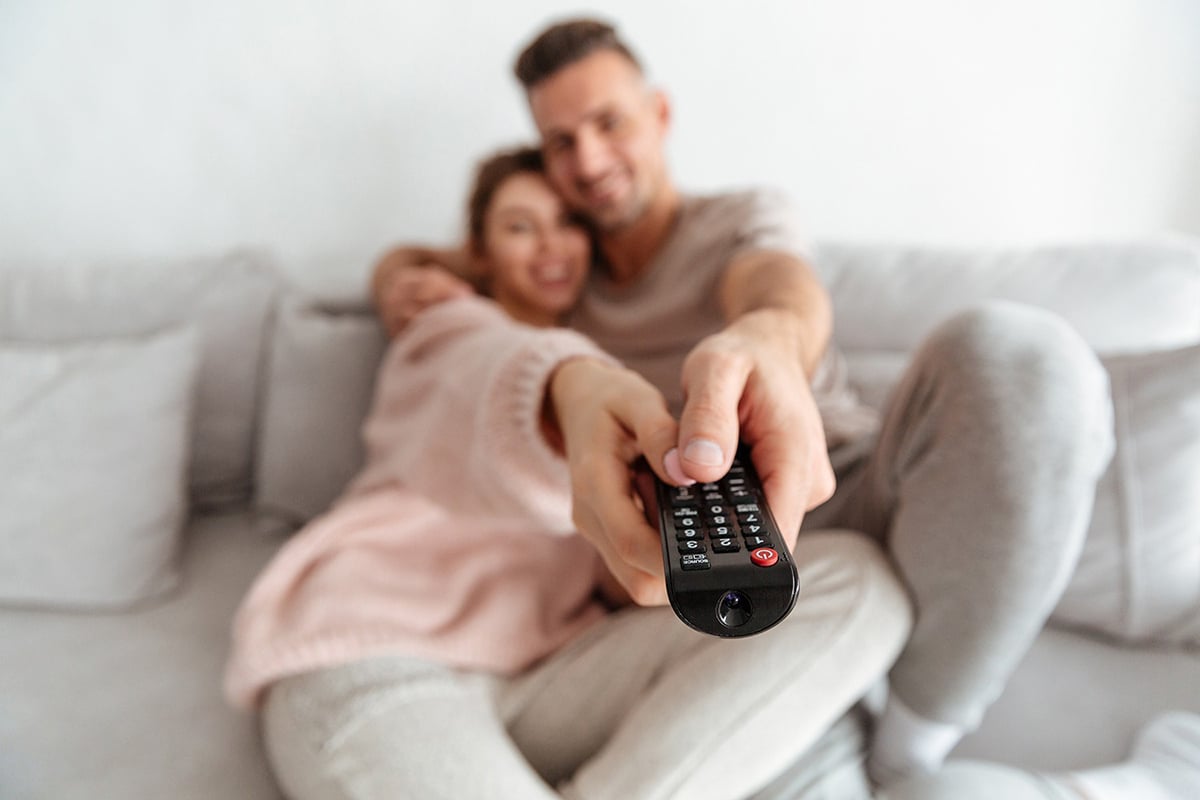 A couple with the TV controller in their hands